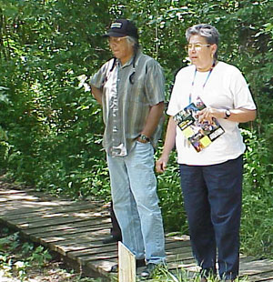 John Jackson and Mary LeClere, members of the Potawatomi Tibe, examine a Missouri Western pond.