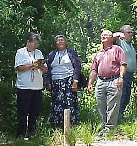 Dr. Rushin, Mary LeClere and Cecelia Jackson make their way through lush vegetation to one of Missouri Western's ponds.